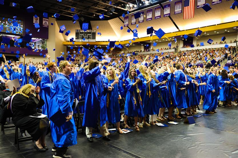 A group of graduates wearing blue robes